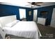 Comfortable bedroom with blue walls, white trim, and contemporary furnishings at 132 Marina Ln, Mooresville, NC 28117