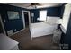 Bedroom with blue walls, white bedding, and ample natural light at 132 Marina Ln, Mooresville, NC 28117