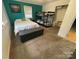 Bright bedroom featuring a twin bed, bunk bed, and a green accent wall at 132 Marina Ln, Mooresville, NC 28117