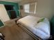 Bedroom with a green accent wall, large window, and a comfortable bed at 132 Marina Ln, Mooresville, NC 28117