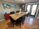 A dining room with a large table and black chairs, a red buffet and a view outside at 132 Marina Ln, Mooresville, NC 28117
