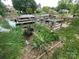 Beautiful lakeside setting with a dock, boats, and a lush garden featuring colorful flowers at 132 Marina Ln, Mooresville, NC 28117