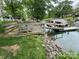 Lakeside home featuring a private dock with boat access and lush landscaping at 132 Marina Ln, Mooresville, NC 28117