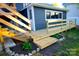 Charming home exterior with wooden stairs, new siding, and landscaped yard at 132 Marina Ln, Mooresville, NC 28117