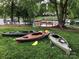 Kayaks on a lawn near the water, with docks and waterfront properties visible in the background at 132 Marina Ln, Mooresville, NC 28117