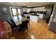 Dining room leading to a kitchen featuring white cabinets, dark countertops, and stainless steel appliances at 132 Marina Ln, Mooresville, NC 28117