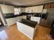 Bright kitchen featuring white cabinets, a center island with a dark countertop and stainless steel appliances at 132 Marina Ln, Mooresville, NC 28117