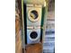 Compact laundry area with stacked Samsung washer and dryer in a rustic space at 132 Marina Ln, Mooresville, NC 28117