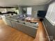 Open-concept living area connecting kitchen, dining, and living spaces featuring wood floors at 132 Marina Ln, Mooresville, NC 28117