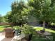 Lush backyard featuring mature trees and a seating area at 14413 Lake Crossing Dr, Charlotte, NC 28278