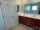 This bathroom contains a double sink vanity with a large mirror at 14413 Lake Crossing Dr, Charlotte, NC 28278