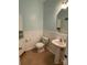 Clean half bathroom with pedestal sink, wainscoting, and white fixtures offering a simple and functional space at 14413 Lake Crossing Dr, Charlotte, NC 28278