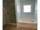 Primary bathroom featuring a tub and a stand-alone shower at 14413 Lake Crossing Dr, Charlotte, NC 28278