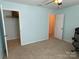 This bedroom has a closet, a large window, and light blue walls at 14413 Lake Crossing Dr, Charlotte, NC 28278