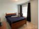 This bedroom includes a window, closet, and a ceiling fan at 14413 Lake Crossing Dr, Charlotte, NC 28278