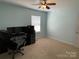 This home's bedroom is spacious and includes a ceiling fan and a large window at 14413 Lake Crossing Dr, Charlotte, NC 28278
