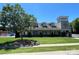Well-maintained community clubhouse with a covered entrance, manicured lawn, and mature trees at 14413 Lake Crossing Dr, Charlotte, NC 28278