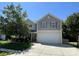 Two-story home featuring a large two-car garage and manicured landscaping at 14413 Lake Crossing Dr, Charlotte, NC 28278