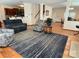 Open living room with carpet, cozy seating, and staircase access at 14413 Lake Crossing Dr, Charlotte, NC 28278