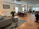 Open-concept living and dining area features wood floors and neutral decor at 14413 Lake Crossing Dr, Charlotte, NC 28278