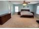 Spacious main bedroom featuring plush carpet, light blue walls, and a large dresser at 14413 Lake Crossing Dr, Charlotte, NC 28278