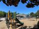 Colorful community playground with slide and climbing structure, surrounded by fencing and mulch at 14413 Lake Crossing Dr, Charlotte, NC 28278