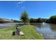 Beautiful view of the pond with picnic tables and a clear blue sky, perfect for relaxation at 14413 Lake Crossing Dr, Charlotte, NC 28278