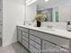 Bathroom features a dual sink vanity with modern fixtures and a large mirror at 148 Tangle River Dr # 67, Statesville, NC 28677