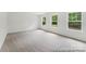 Spacious carpeted bedroom with three large windows providing ample natural light at 148 Tangle River Dr # 67, Statesville, NC 28677