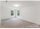 Bright carpeted bedroom with two large windows and a scenic outdoor view at 148 Tangle River Dr # 67, Statesville, NC 28677