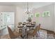 Bright dining area featuring a glass table, stylish chairs, and views of the backyard at 148 Tangle River Dr # 67, Statesville, NC 28677