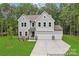 Charming two-story home with a manicured lawn, attached two-car garage, and neutral gray siding at 148 Tangle River Dr # 67, Statesville, NC 28677