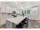 Bright kitchen with white cabinets, an island with seating, and modern appliances at 148 Tangle River Dr # 67, Statesville, NC 28677