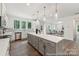 Open kitchen boasts a large island, stainless steel appliances, and contemporary finishes at 148 Tangle River Dr # 67, Statesville, NC 28677