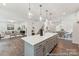 Spacious kitchen featuring an island, wood floors, and an open layout into the living area at 148 Tangle River Dr # 67, Statesville, NC 28677