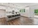 Modern kitchen with an island, counter seating, stainless steel appliances, and wood floors at 148 Tangle River Dr # 67, Statesville, NC 28677
