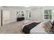 Open primary bedroom boasts neutral carpet, large windows, and a spacious layout at 148 Tangle River Dr # 67, Statesville, NC 28677