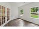 Bright office features hardwood floors, double french doors, and two large windows with an outdoor view at 148 Tangle River Dr # 67, Statesville, NC 28677