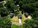 An aerial view showcases three modern homes nestled amidst lush trees and expansive green lawns at 1645 Carolina Cir, Gastonia, NC 28054
