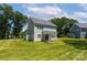 A well-maintained backyard features a lush lawn and ample space surrounding a light-blue, two-story house at 1645 Carolina Cir, Gastonia, NC 28054
