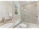 Modern bathroom featuring a glass shower, granite countertop, and ample natural light at 1645 Carolina Cir, Gastonia, NC 28054