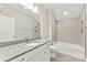 Bright bathroom featuring a granite-topped vanity, white cabinetry, subway tile, and a bathtub-shower combo at 1645 Carolina Cir, Gastonia, NC 28054