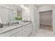 Elegant bathroom with double vanity, granite countertops, and a glass-enclosed shower, complemented by a spacious walk-in closet at 1645 Carolina Cir, Gastonia, NC 28054