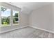 Attic bedroom featuring plush carpeting, neutral paint, and bright windows overlooking the exterior at 1645 Carolina Cir, Gastonia, NC 28054