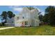 Charming light gray home with an attached garage, red front door, and a well-manicured lawn at 1645 Carolina Cir, Gastonia, NC 28054