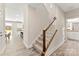 Bright hallway with a carpeted staircase and views of the modern kitchen and bathroom at 1645 Carolina Cir, Gastonia, NC 28054