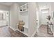 Hallway with built-in storage bench, coat hooks, and seamless access to other rooms at 1645 Carolina Cir, Gastonia, NC 28054
