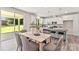 Bright, open kitchen features stainless appliances, granite countertops, and bar seating, complemented by a dining area and backyard view at 1645 Carolina Cir, Gastonia, NC 28054