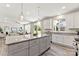 Open-concept kitchen with granite island, white cabinets, and stainless steel appliances, flowing into the living area at 1645 Carolina Cir, Gastonia, NC 28054