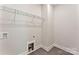 The laundry room's minimal design is highlighted by its shelving and modern floors at 1645 Carolina Cir, Gastonia, NC 28054